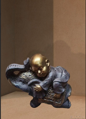 Intricately Designed Artefact of a Person Sitting on an Elephant A Symbol of Majesty and Grace