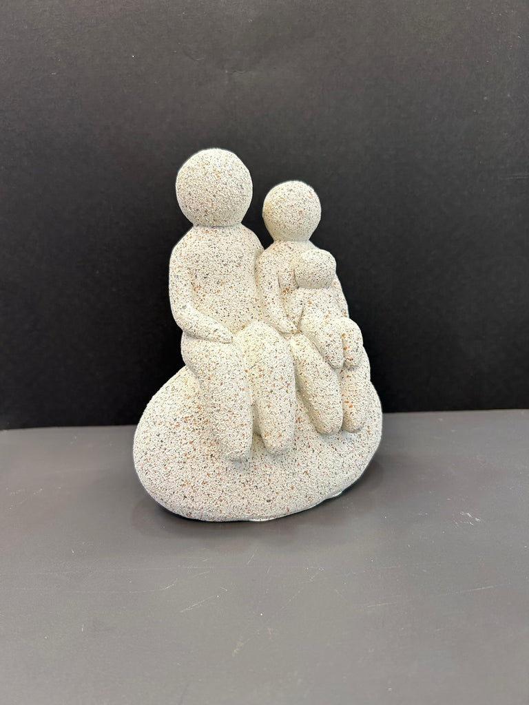 White Colour Artefact of Family Seated on a Rock